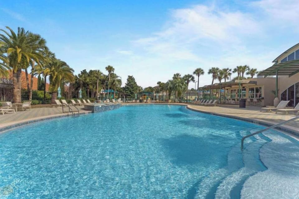 Sparkling pool surrounded by swaying palms and sunny loungers—perfect for leisurely afternoons cooling off in the Florida sunshine. Relax poolside or take a refreshing dip anytime.