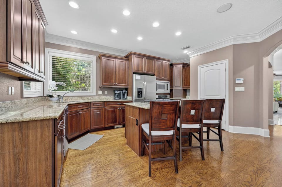 Step into your gourmet kitchen, where rich wood cabinetry, gleaming granite countertops, and modern appliances invite you to cook and gather with loved ones.