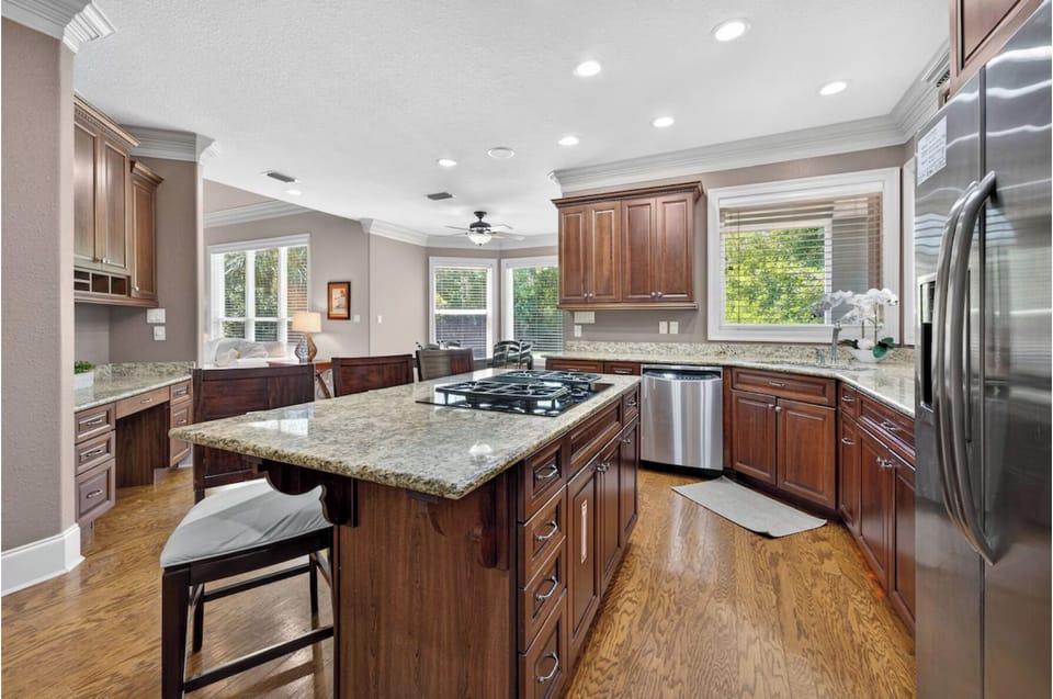 Gather around this chef's kitchen featuring granite countertops, stainless steel appliances, and a large island—your home base for memorable meals.