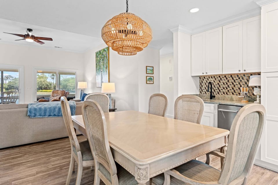 Dining area with seating for six and peaceful marsh views beyond