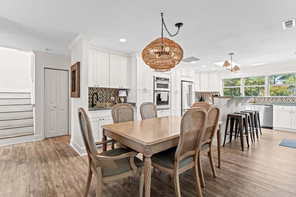 Dining area with seating for six and peaceful marsh views beyond