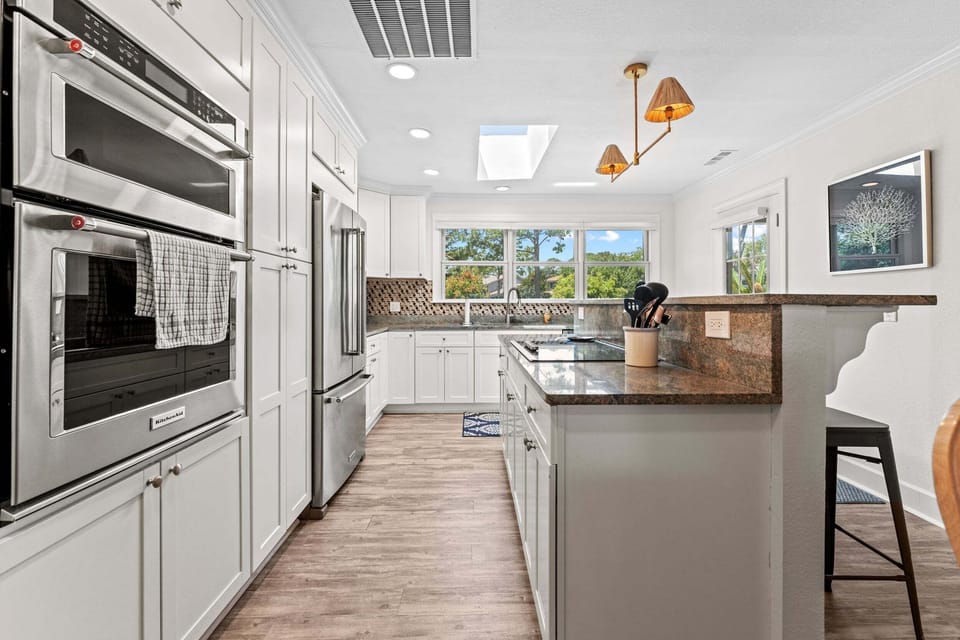 Large kitchen island with seating for four — ideal for casual breakfasts and happy hour gatherings