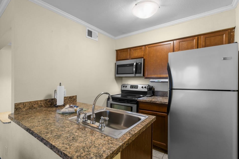 Cook with ease in this modern kitchen, complete with full appliances and sleek countertops.