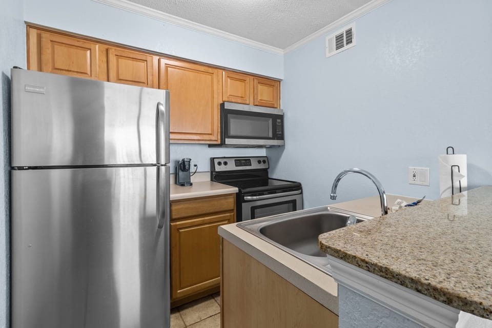 Whip up meals in this well-equipped kitchen, complete with modern appliances and granite countertops.