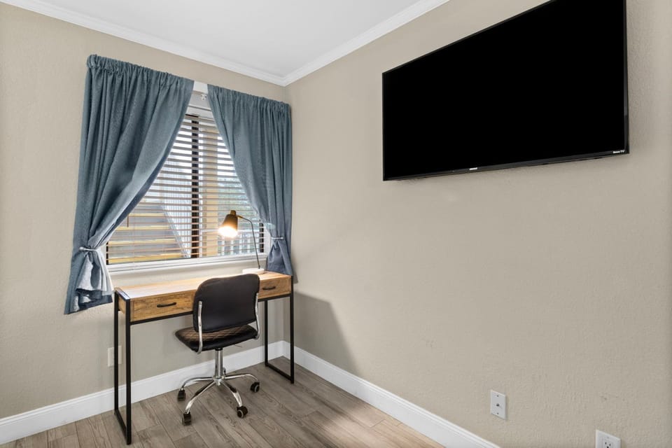 Settle into a well-designed space featuring a desk and cozy chair, perfect for work or planning your adventures.