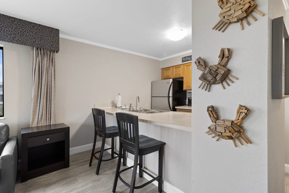 Gather around the kitchen bar for casual meals or lively conversations in a bright, welcoming space.