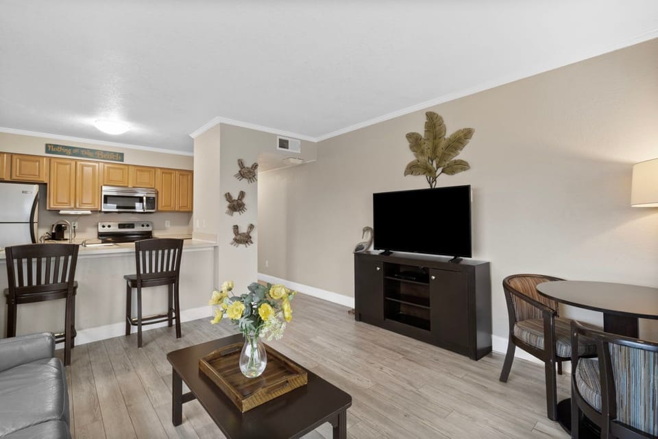 Enjoy the simple elegance of your living space, featuring a lovely seating area and a touch of nature-inspired decor.