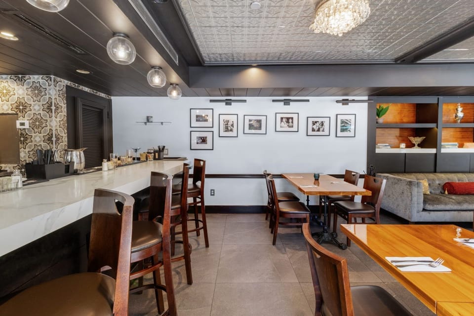 Step into a stylish dining space, featuring elegant decor and inviting seating for a cozy meal.
