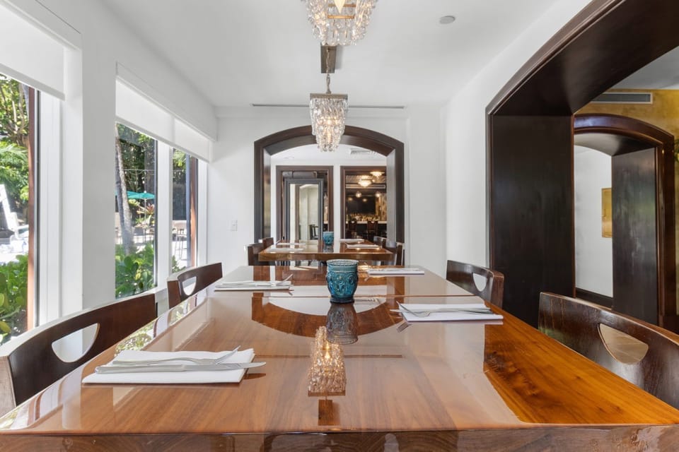 Dine in style surrounded by natural light, with a view of lush greenery just outside the windows.