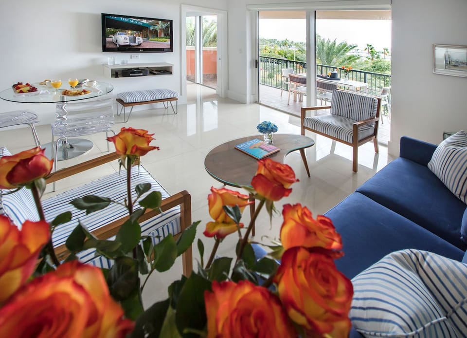 Unwind in a stylish living area adorned with fresh flowers and inviting seating options.