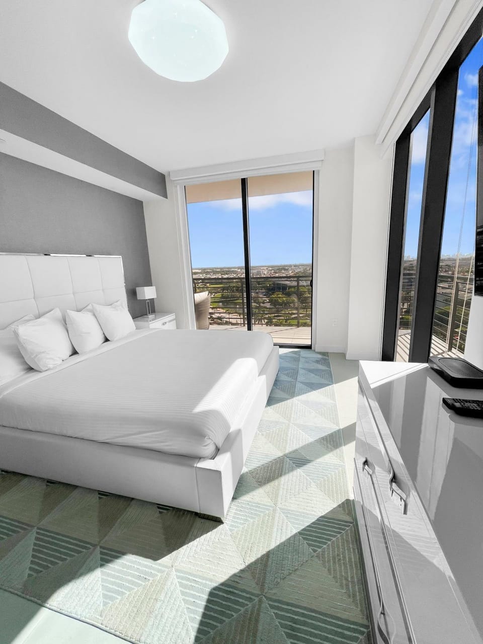 Relax in this cozy bedroom, featuring a plush king bed and natural light filling the space.