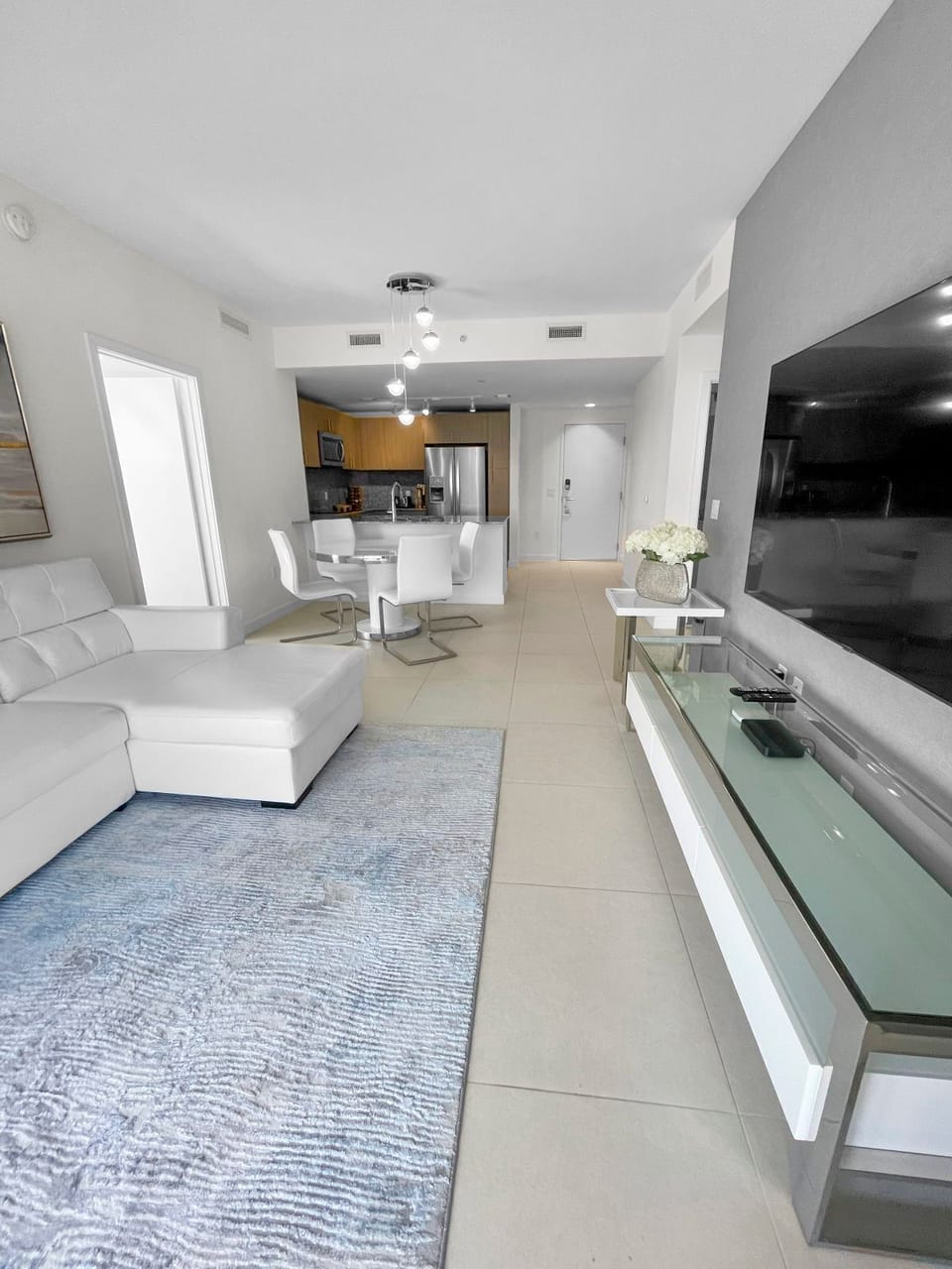 Relax in the stylish living area, featuring a plush sofa and chic decor, perfect for unwinding with loved ones.