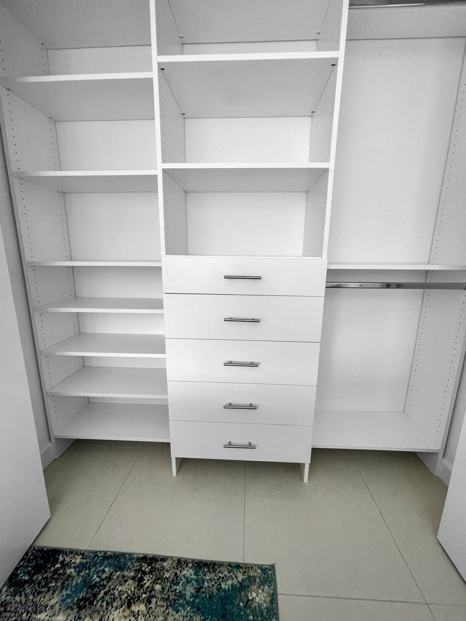 Organize your wardrobe in this sleek, spacious closet with ample storage options.