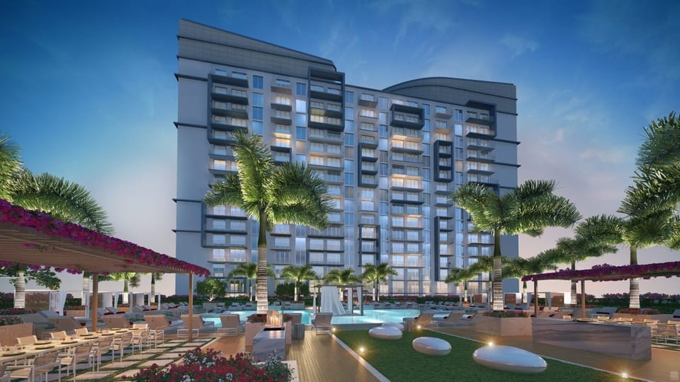 Experience elegant outdoor lounging by the shimmering pool, surrounded by lush tropical plants.