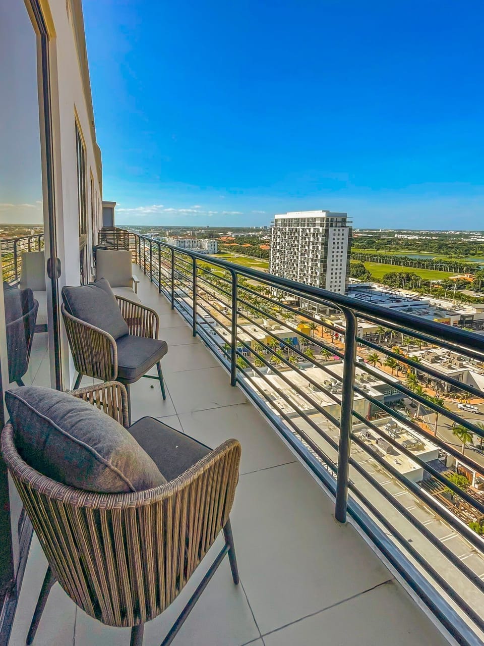 Relax on the balcony with stylish seating, enjoying the fresh air and uninterrupted blue skies.