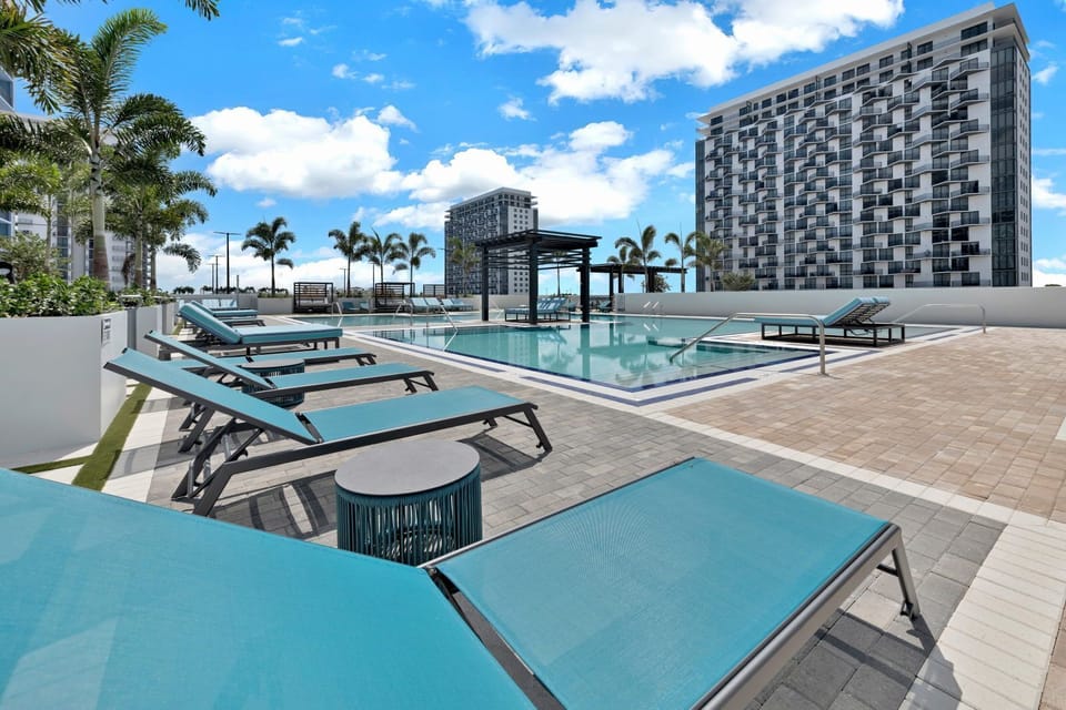 Lounge in style beside the resort-style pool, with chic seating and modern architecture in view.