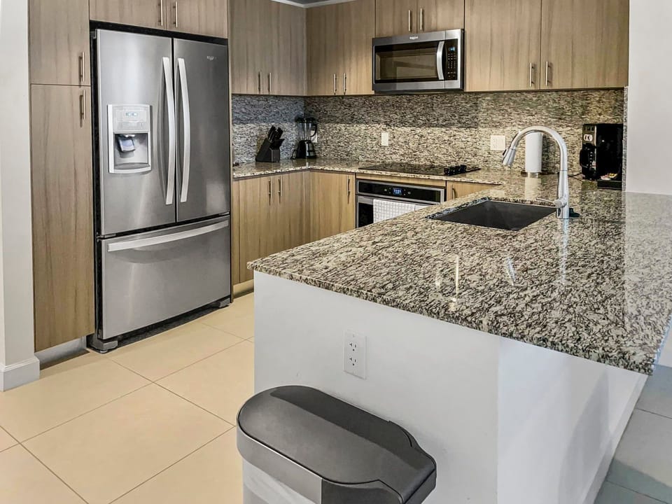 Cook and entertain in a modern kitchen featuring sleek stainless steel appliances and ample counter space.