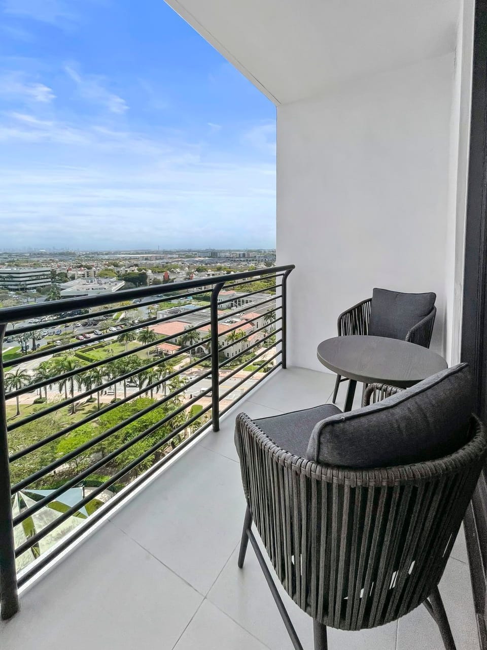 Enjoy your morning coffee on the private balcony with comfortable seating and city views.