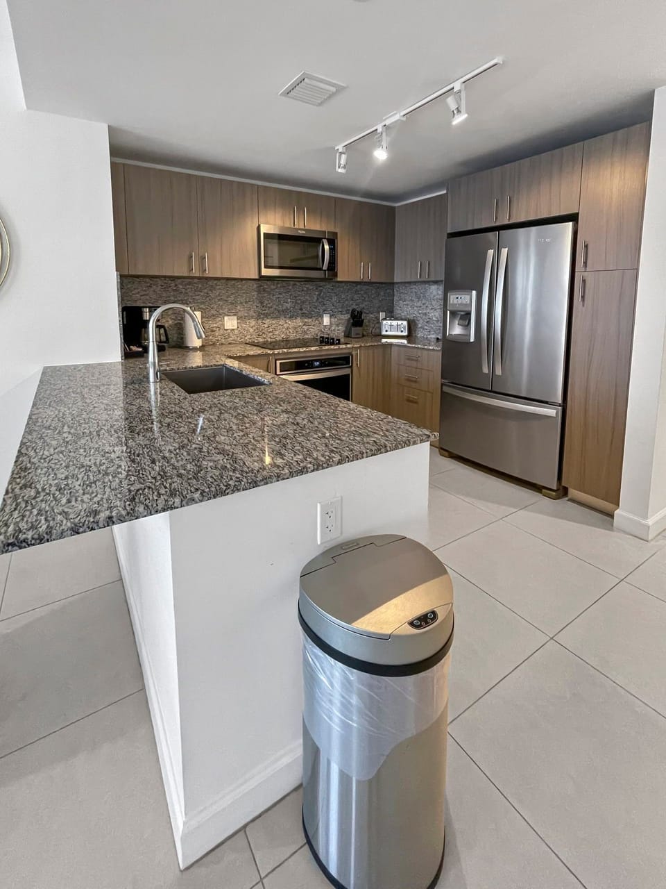Cook in style with modern appliances and sleek granite countertops in this fully equipped kitchen.