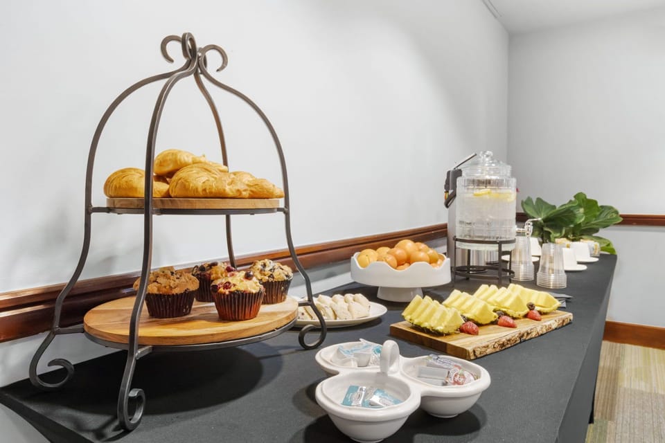 Indulge in a delightful spread of pastries and fresh fruit for your morning boost.