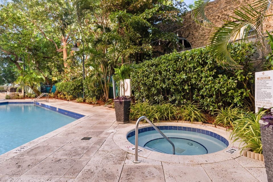 Relax in the bubbling hot tub surrounded by lush greenery, perfect for unwinding after a day of adventure.