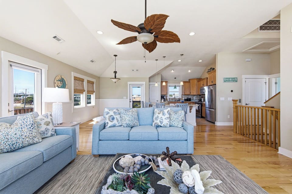 Bright coastal great room with vaulted ceilings and open kitchen