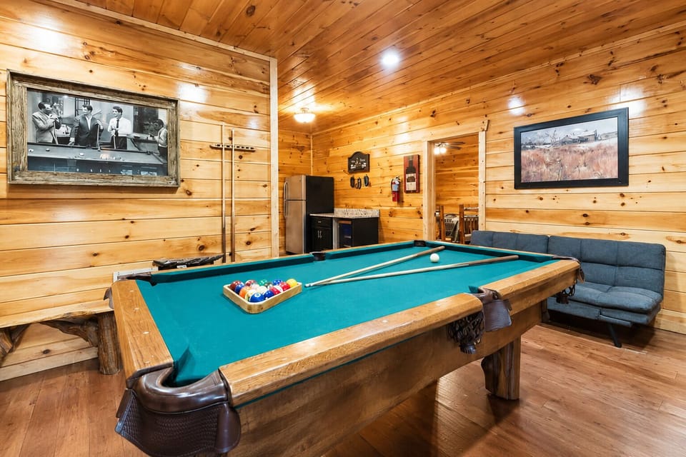 Spacious game room with pool table, rustic wood walls, and entertainment space perfect for family gatherings and Smoky Mountain cabin vacations in Tennessee.