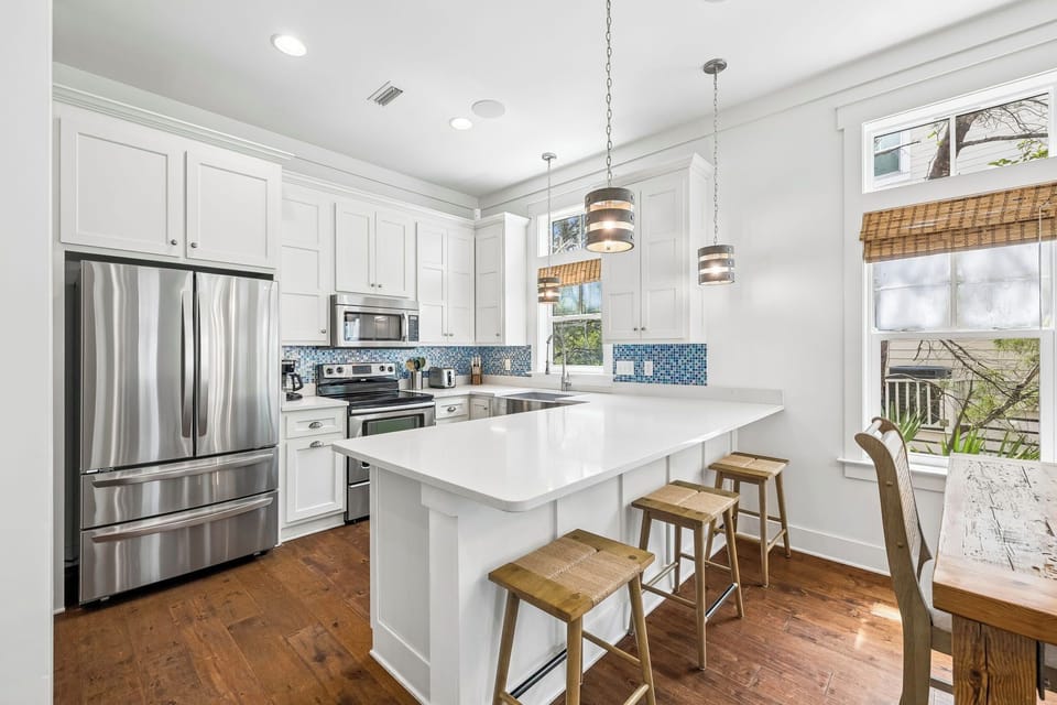 Cook up a feast in this bright, fully-equipped kitchen with modern appliances, a spacious island, and serene views inviting you to savor every moment here.