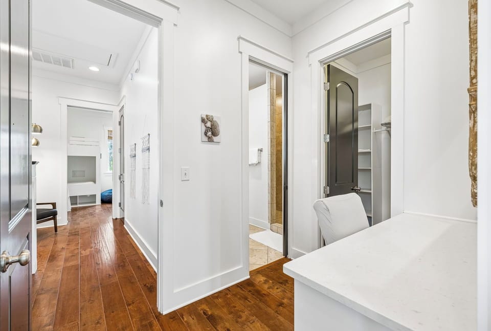This bright hallway flows through the heart of your space, connecting a cozy bedroom, a tiled bathroom, and your dedicated laundry area—everything tucked neatly within reach for your comfort and convenience.
