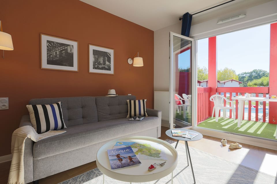 The bright living area opens onto a private terrace, giving you that perfect indoor-outdoor balance after a day exploring the Basque coastline.