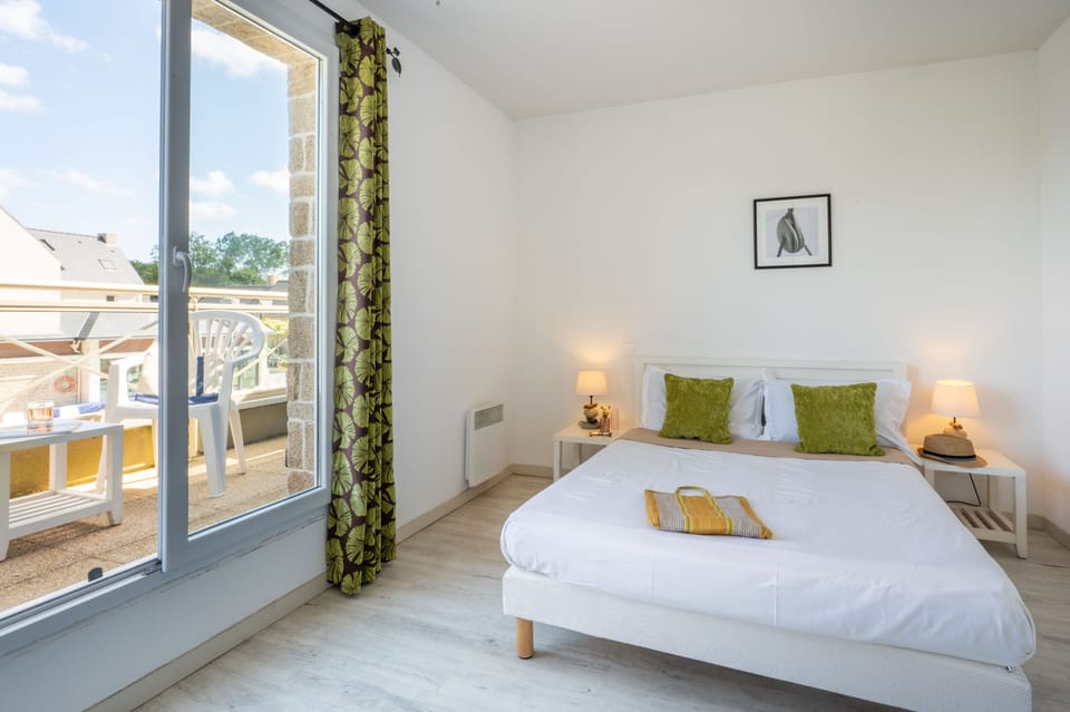 The spacious double bedroom upstairs is a bright, serene space to retreat to after a full day discovering Saint-Malo and its coastline.