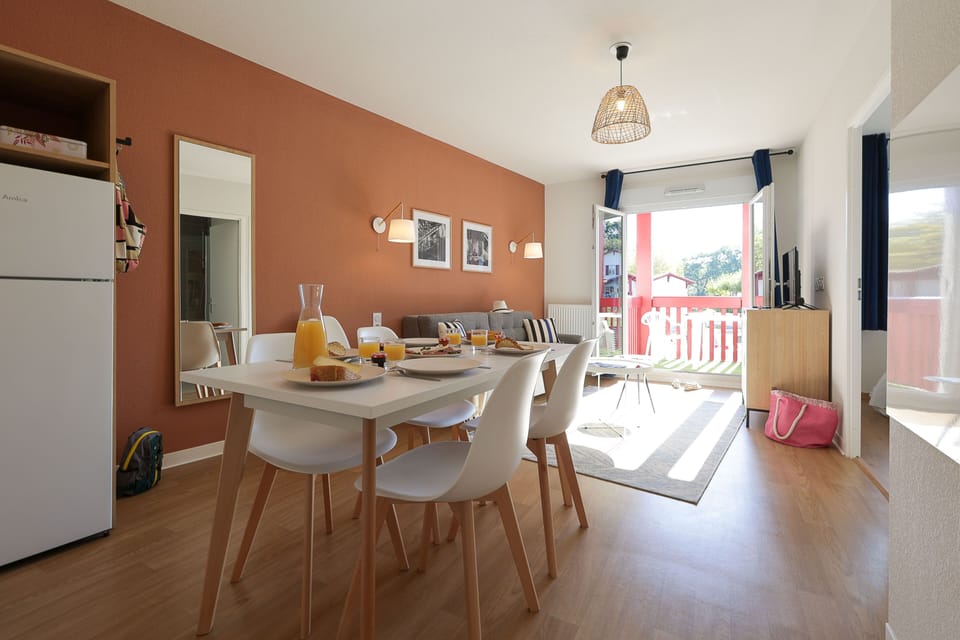 Whether it's a leisurely breakfast or a dinner after a day at the beach, the bright dining area is the natural gathering point for the whole group.
