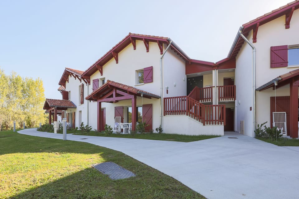 These charming Basque-style apartments offer easy access to all resort amenities, with lush green surroundings that make coming back after a day out just as enjoyable.