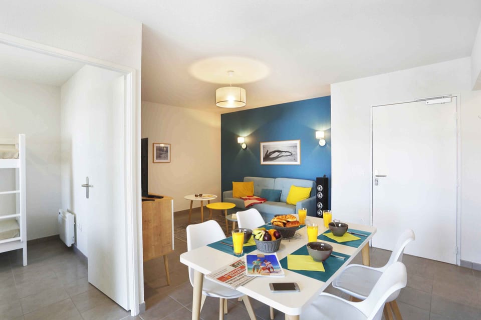 Gather around the dining table in the vibrant living area, perfect for meals and games.