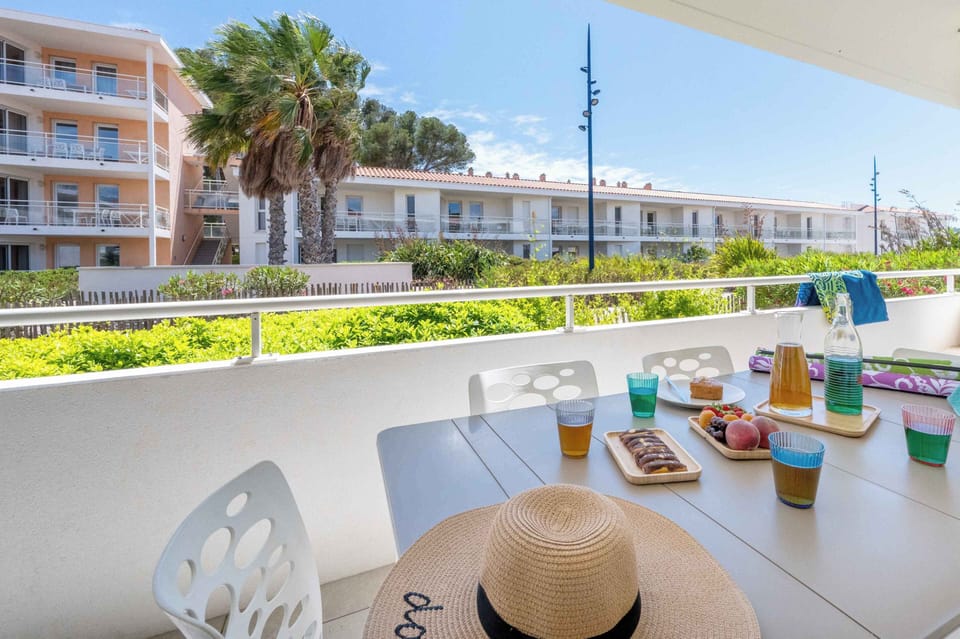 Sun-drenched terrace with outdoor dining — enjoy your morning coffee or an evening apéritif just steps from the beach.