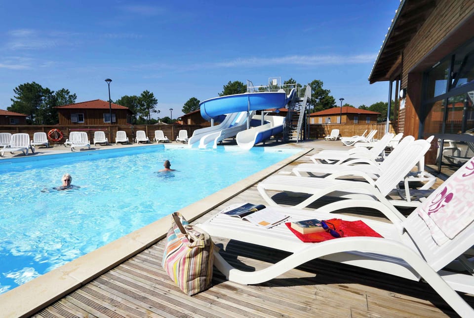 Poolside loungers line the sun-drenched deck — the Atlantic beaches are just 3 km away when you're ready to explore.