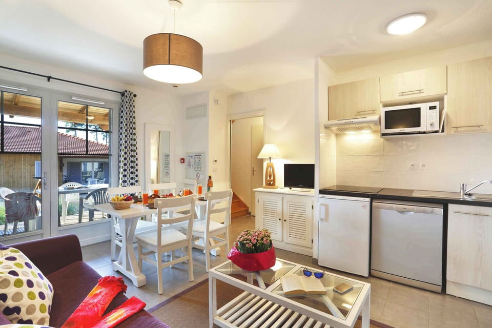 Fully equipped kitchen with hotplates, microwave, fridge, dishwasher, coffee maker, and toaster — all included.