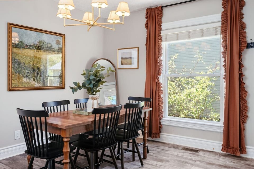 Bright and modern farmhouse dining room with a wooden table and chairs. 🍽️