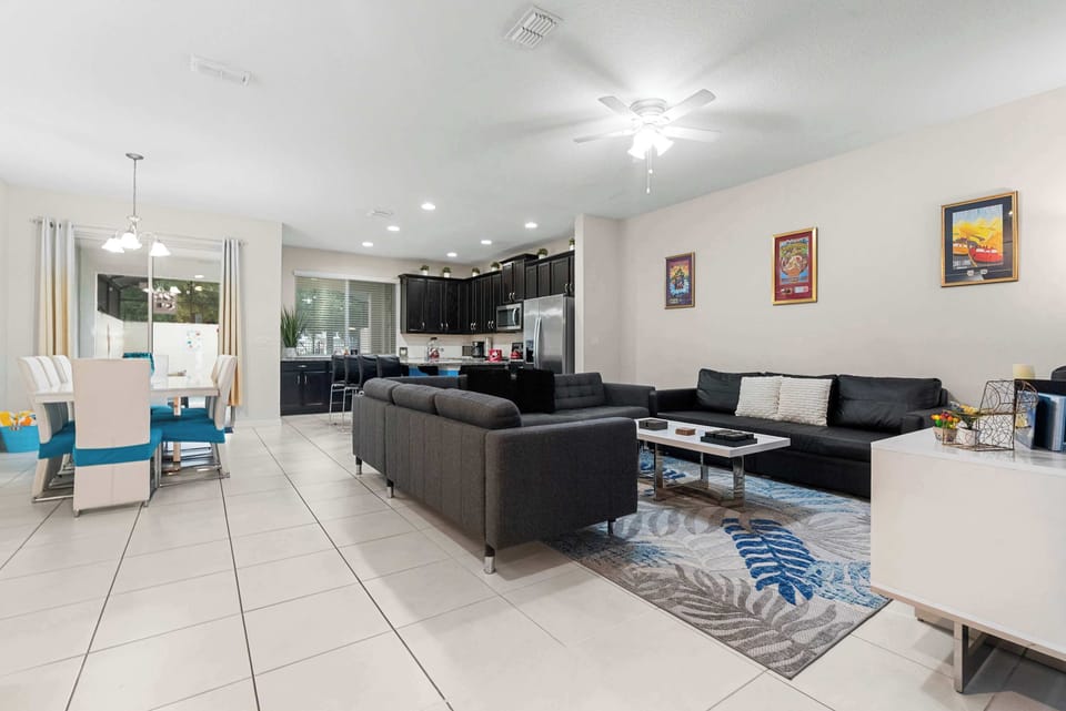 Open-concept living and dining area with modern kitchen and ample seating for family gatherings.
