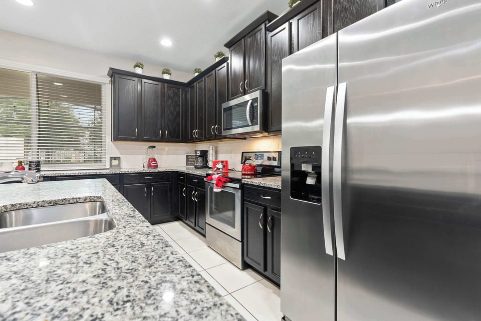 Modern kitchen with granite countertops and stainless steel appliances
