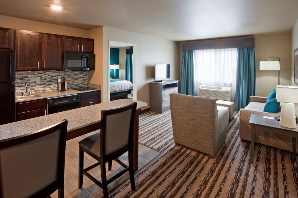 Premium bedding, desk, laptop workspace, blackout drapes
