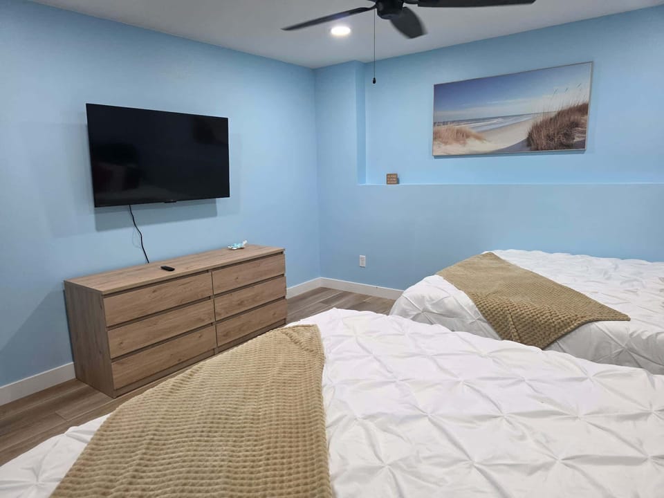 Cozy up for a relaxing movie night in this spacious sixth bedroom, featuring comfortable seating and a smart TV perfect for unwinding after a day of lakefront adventures.