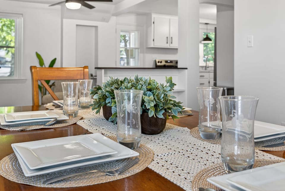 Bright open dining area with stylish table setting and modern kitchen views