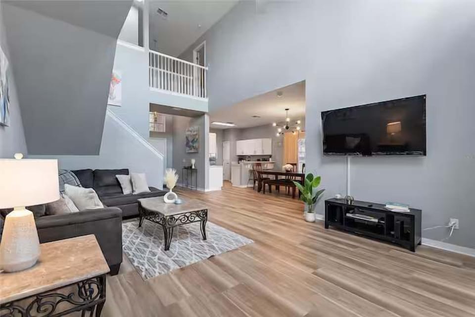 Open-concept living area w/ TV, hardwood floors & plenty of room to relax.
