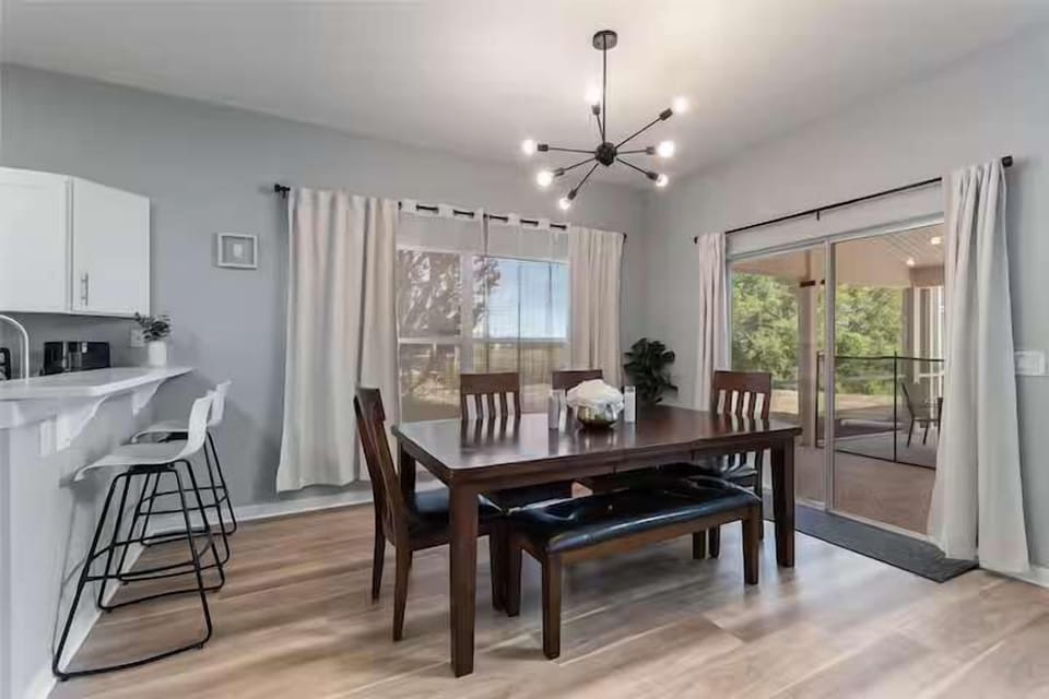 Elegant dining area w/ chandelier, seating for the whole group.
