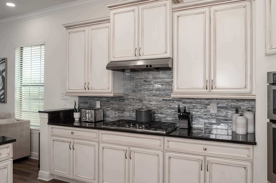 kitchen with vintage-style cabinetry and a modern stainless steel stove