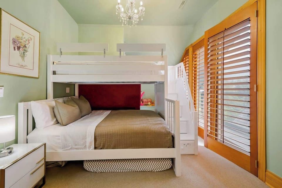 Bunk bed with a queen on the bottom and twin on the top, Smart TV, and private balcony with an ensuite bathroom with a bathtub. 