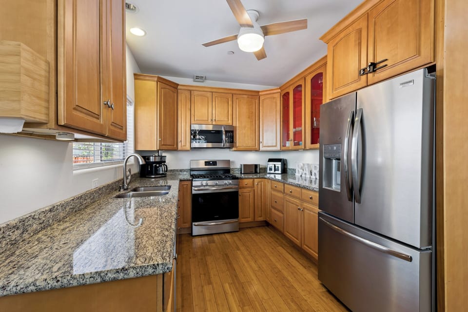Your fully-equipped kitchen features gleaming granite countertops, stainless steel appliances, and all the essentials for preparing delicious home-cooked meals during your stay.