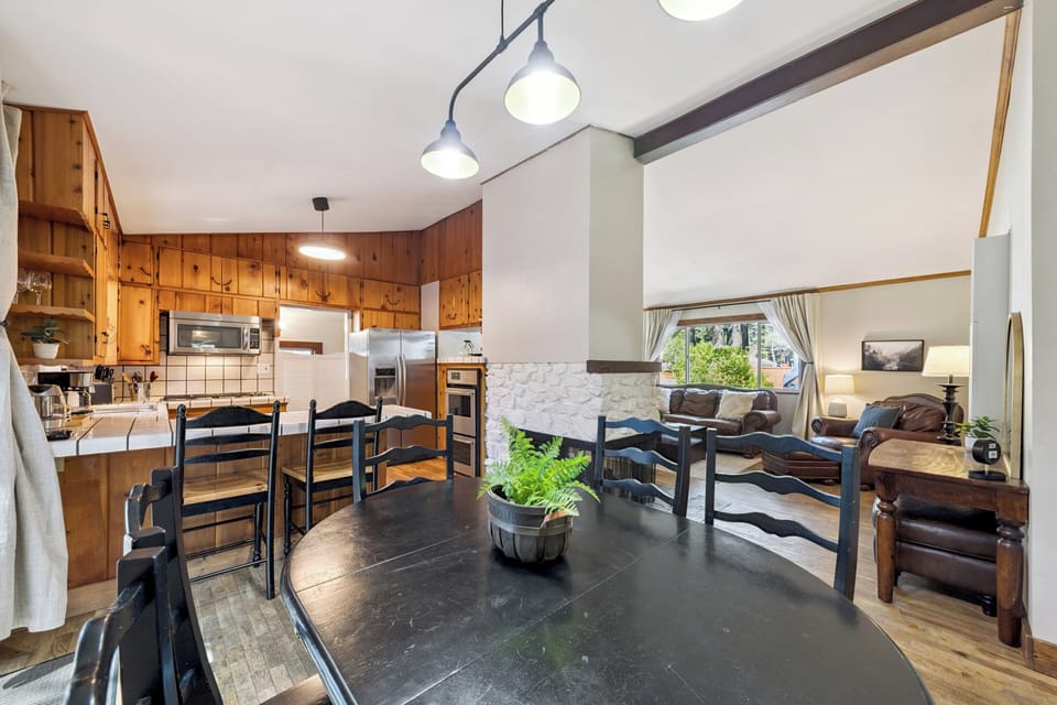 Gather around this inviting dining table, where warm wood tones and modern touches create the perfect spot for your group meals and morning coffee rituals.