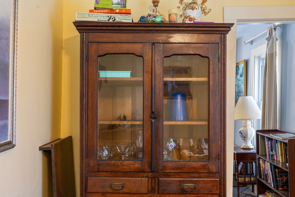 Our 1870s dining room is stocked for family fun with classic board games. This antique cabinet reflects the unbroken lineage of the Somes family, who have cared for this home across six generations in the heart of historic Somesville.